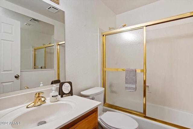 full bathroom featuring shower / bath combination with glass door, vanity, and toilet