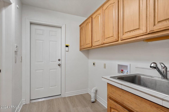 laundry room featuring cabinets, hookup for a washing machine, electric dryer hookup, sink, and light hardwood / wood-style floors