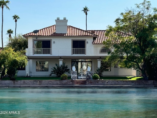 back of property with a balcony