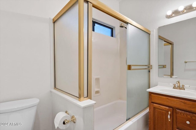 full bathroom featuring vanity, toilet, and bath / shower combo with glass door