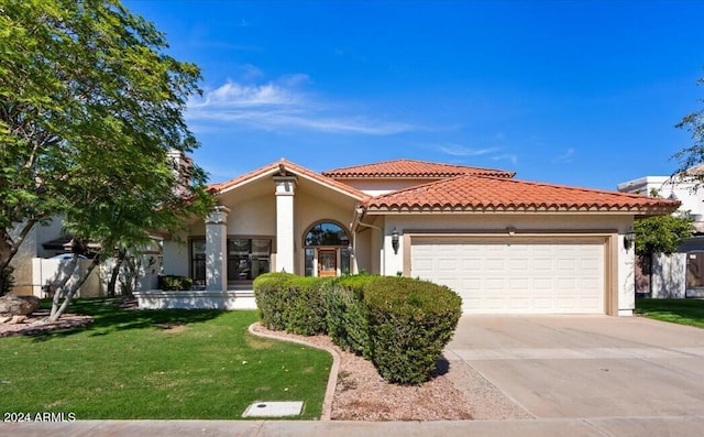 view of front of home with a garage and a front lawn