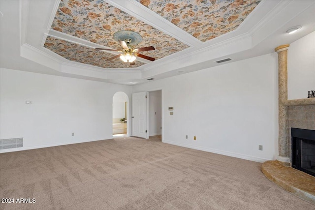 carpeted living room with ceiling fan, crown molding, and a tray ceiling