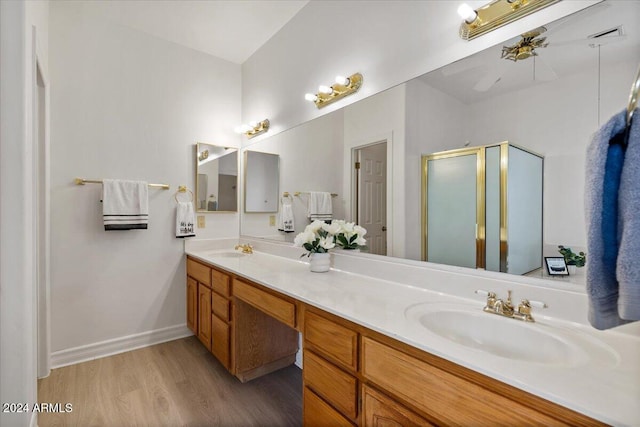 bathroom featuring hardwood / wood-style floors, vanity, and a shower with door