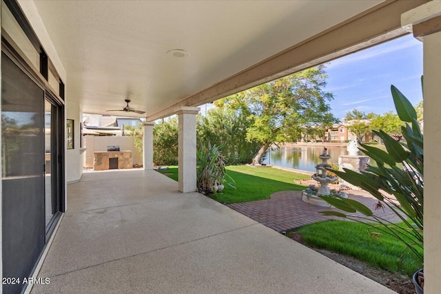 view of patio featuring ceiling fan and a water view