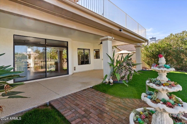 rear view of house featuring a balcony and a patio area