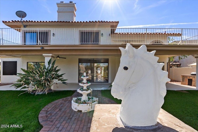 back of property featuring a balcony and a patio area