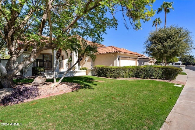 view of front facade featuring a front yard and a garage