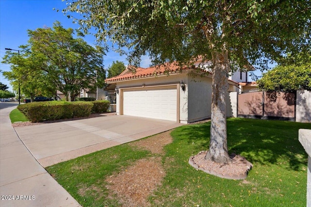 view of front of property featuring a front lawn and a garage