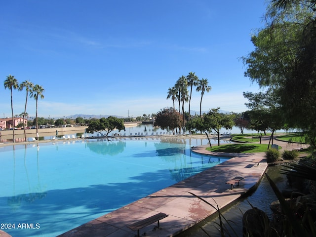 view of swimming pool with a water view