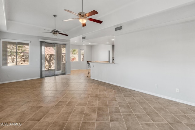 unfurnished living room featuring light tile patterned flooring and ceiling fan