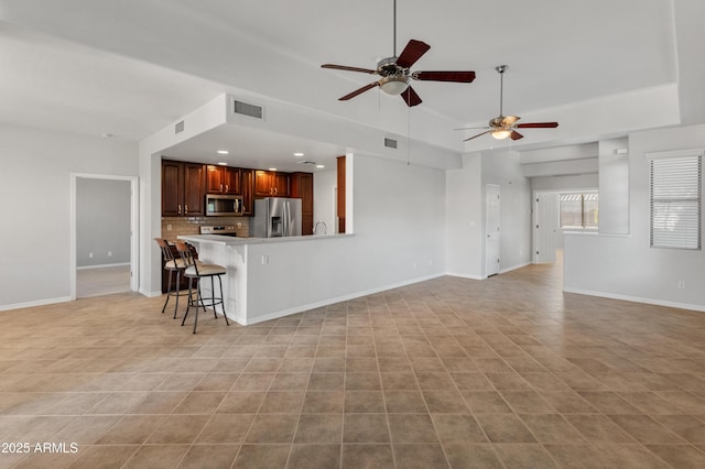 unfurnished living room with ceiling fan and light tile patterned flooring