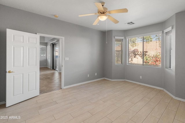 spare room featuring light hardwood / wood-style flooring and ceiling fan