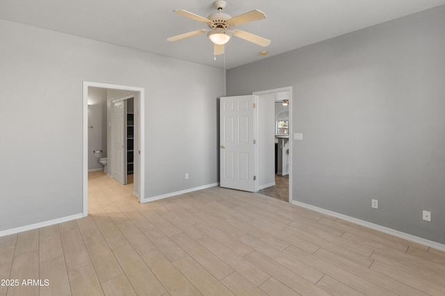 unfurnished bedroom featuring connected bathroom, ceiling fan, and light hardwood / wood-style flooring