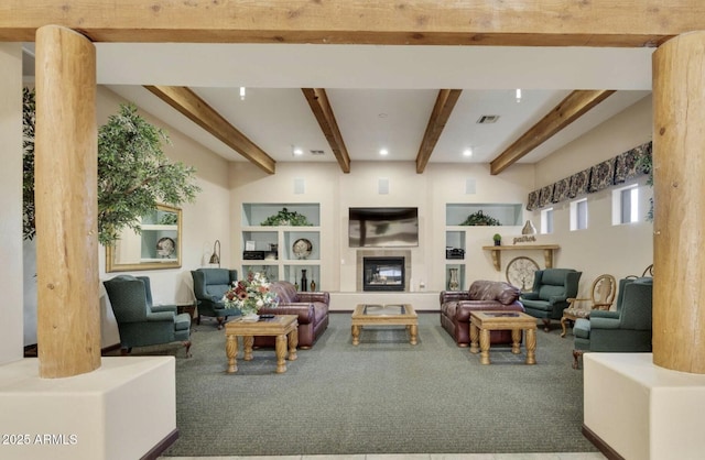 carpeted living room with beam ceiling and built in shelves