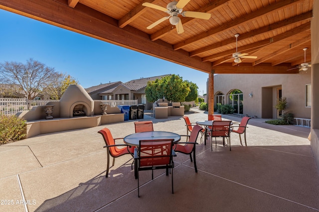 view of patio / terrace featuring exterior fireplace and ceiling fan