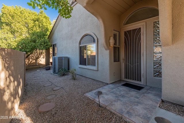 doorway to property featuring a patio and cooling unit