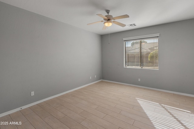 empty room featuring ceiling fan and light hardwood / wood-style flooring