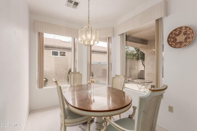 dining room with a chandelier, visible vents, plenty of natural light, and baseboards