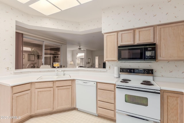 kitchen featuring white appliances, light brown cabinets, and wallpapered walls