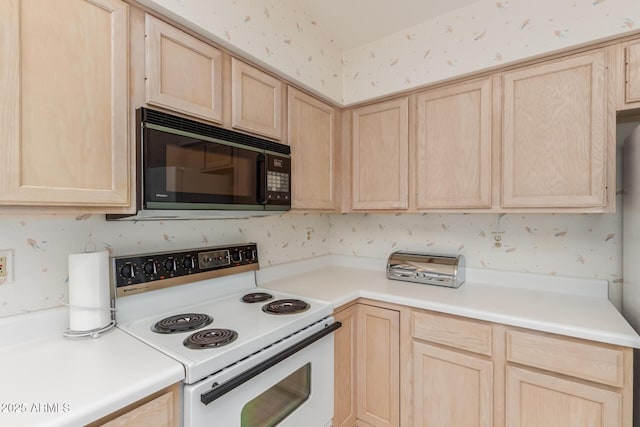 kitchen with white range with electric cooktop, light countertops, light brown cabinets, black microwave, and wallpapered walls