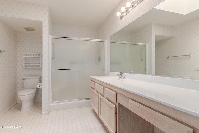 bathroom with wallpapered walls, a stall shower, visible vents, toilet, and vanity