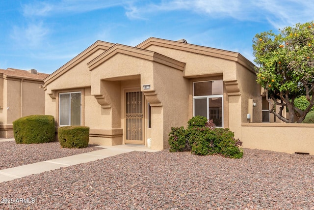 view of front of house featuring fence and stucco siding