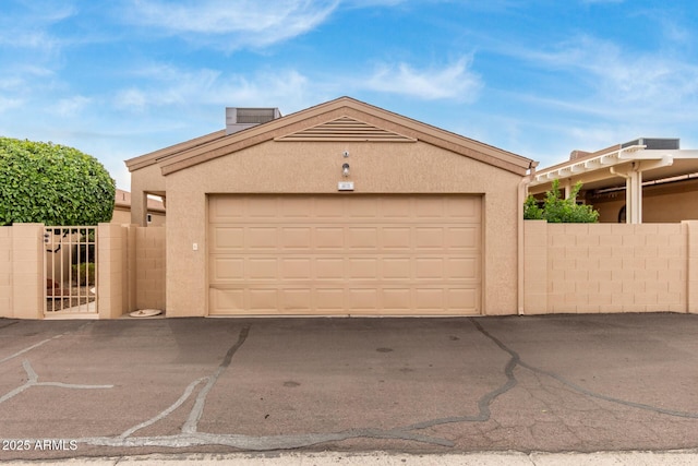 garage with a gate and fence