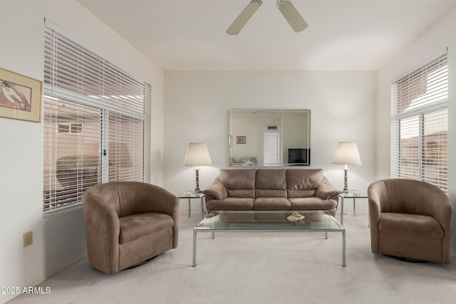 living area featuring carpet floors and a ceiling fan