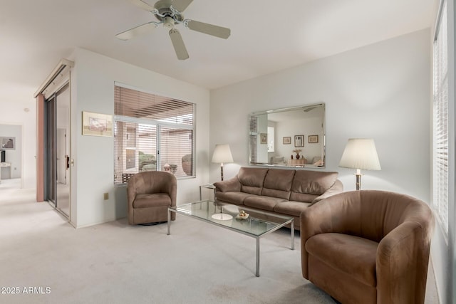 living room featuring a ceiling fan and carpet flooring