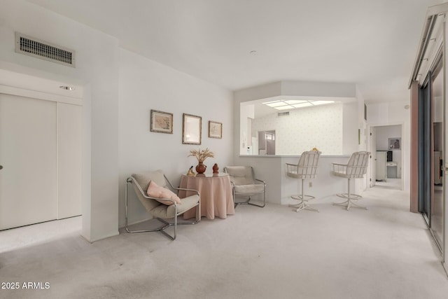 sitting room with carpet floors and visible vents