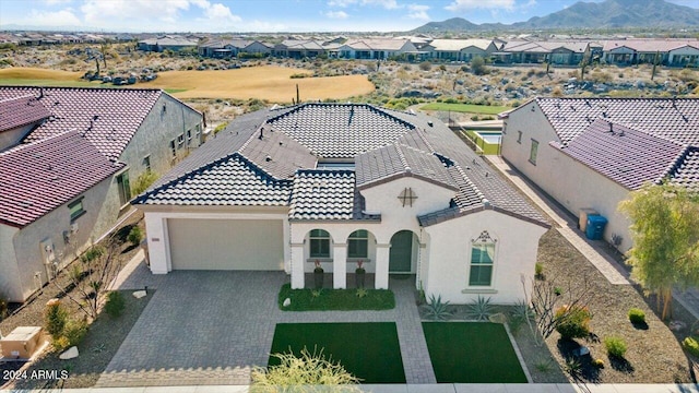 view of front facade with a mountain view and a garage