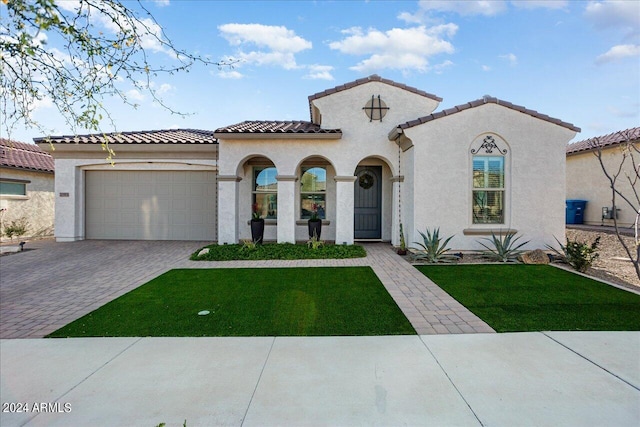 mediterranean / spanish-style house with a front yard and a garage