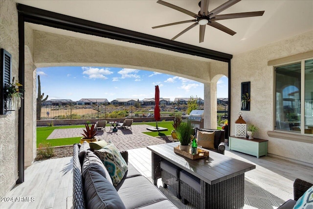 view of patio / terrace featuring ceiling fan and an outdoor living space