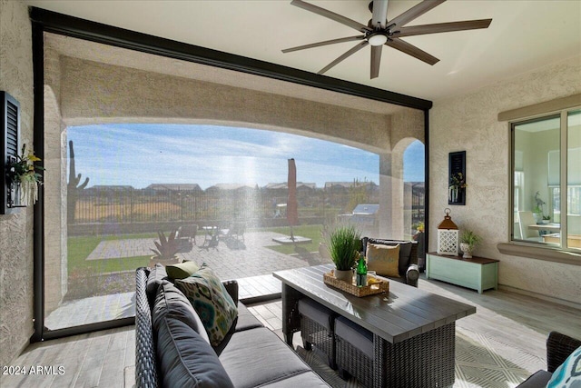 sunroom / solarium featuring ceiling fan