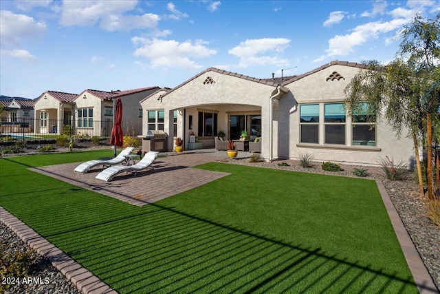 back of house with a yard and a patio area