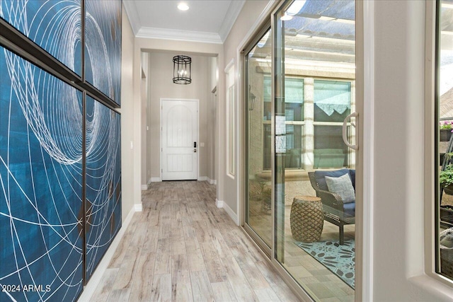 hallway featuring plenty of natural light, crown molding, and light hardwood / wood-style flooring