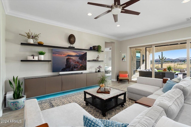 living room featuring ceiling fan and crown molding