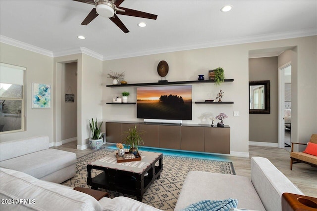 living room featuring ceiling fan, light hardwood / wood-style flooring, and ornamental molding