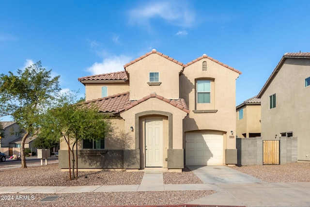 mediterranean / spanish-style house with a garage