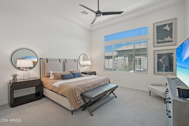 carpeted bedroom with a ceiling fan, visible vents, and baseboards