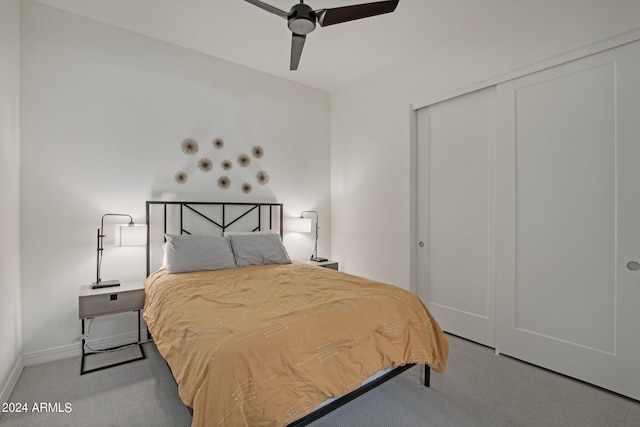 carpeted bedroom with a closet, a ceiling fan, and baseboards