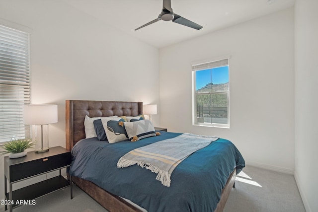 carpeted bedroom with baseboards and a ceiling fan