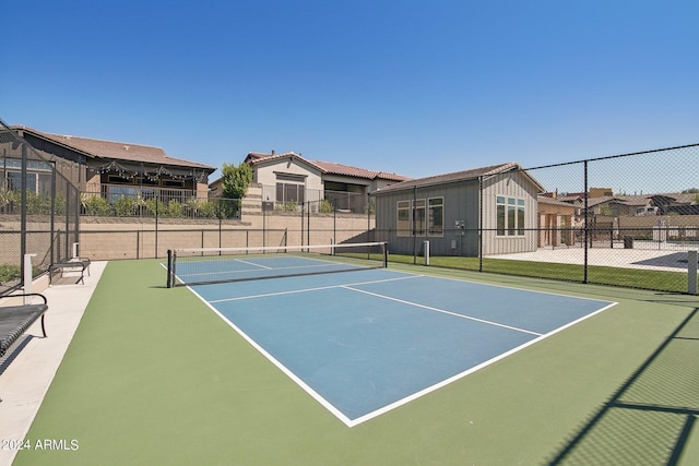 view of sport court featuring a residential view and fence