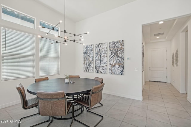 dining room with an inviting chandelier, visible vents, baseboards, and light tile patterned flooring