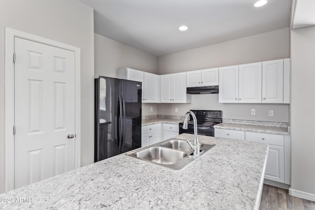 kitchen with white cabinets, hardwood / wood-style floors, black appliances, and sink