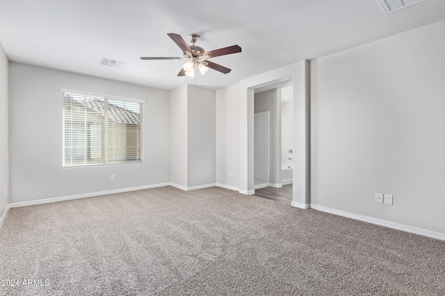 empty room featuring carpet flooring and ceiling fan