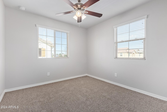 spare room with ceiling fan and carpet flooring