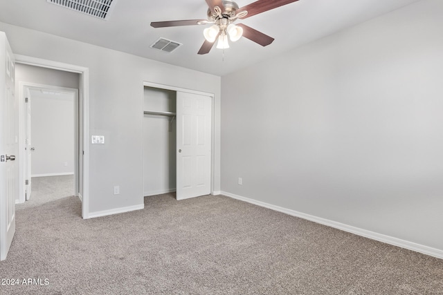 unfurnished bedroom with ceiling fan, light carpet, and a closet