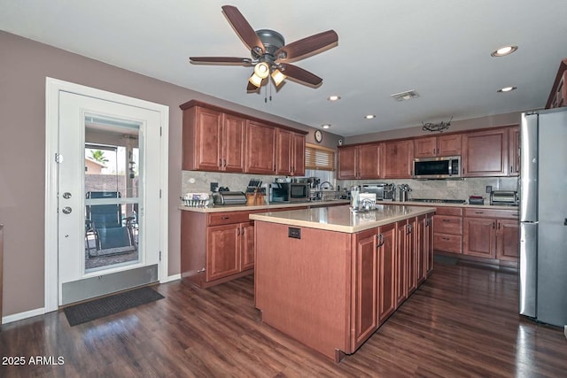 10806 W Adam Ave, Peoria, AZ 85373 - kitchen featuring appliances with stainless steel finishes, light countertops, dark wood finished floors, decorative backsplash, and ceiling fan