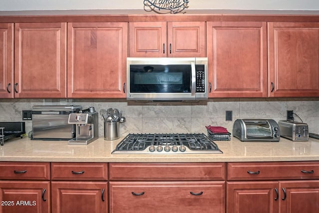 10806 W Adam Ave, Peoria, AZ 85373 - kitchen with appliances with stainless steel finishes, backsplash, and light stone counters